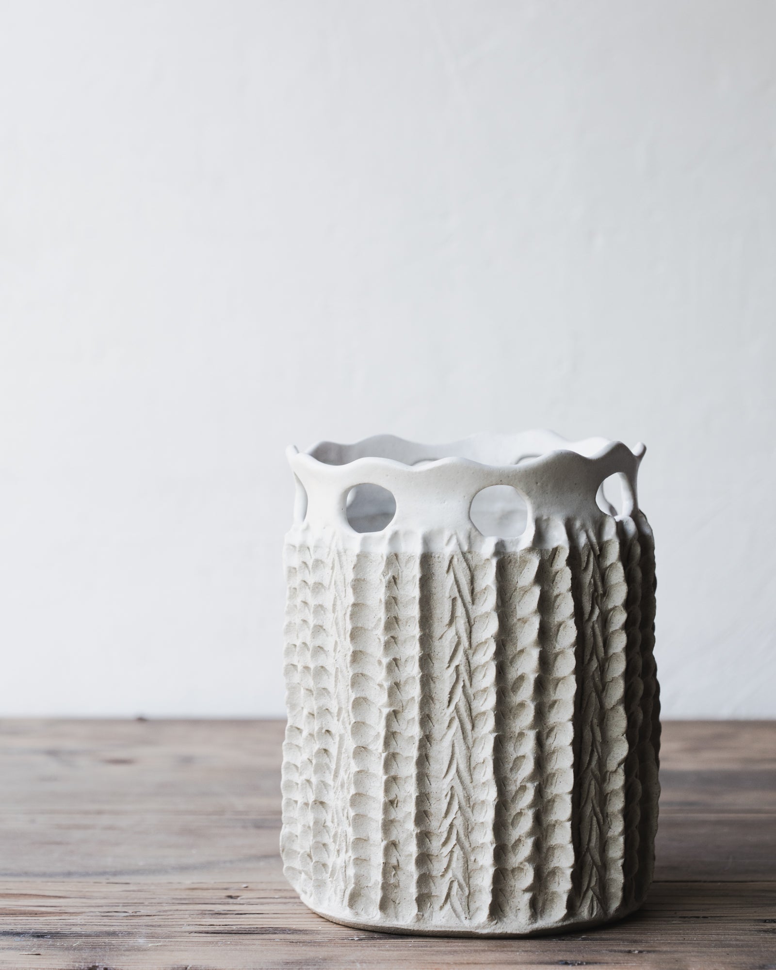 Large handmade vase with textures and cutout design in satin white by clay beehive