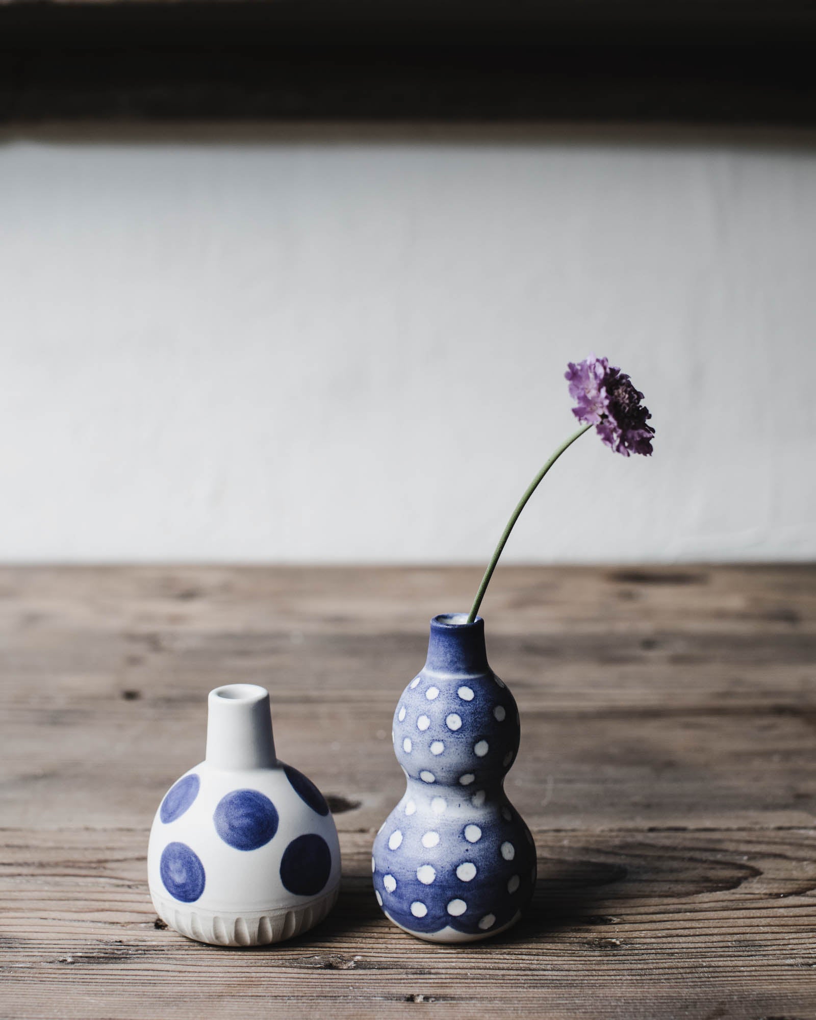 Wheel thrown bud vase with blue and white spots by clay beehive ceramics.