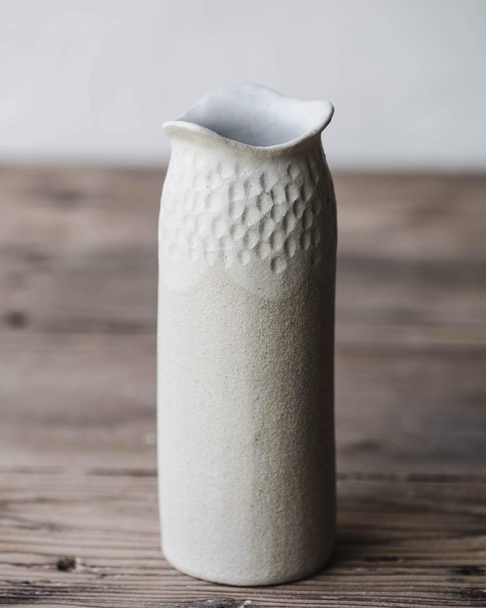 White vase with carved textured handmade by clay beehive ceramics
