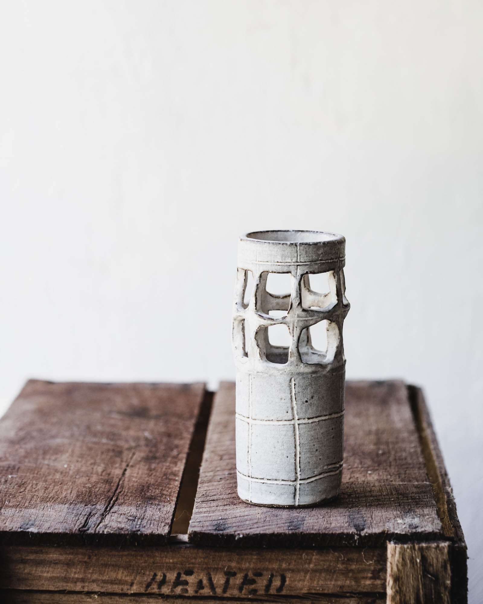 quirky cutout handmade vase in soft grey and white by clay beehive ceramics