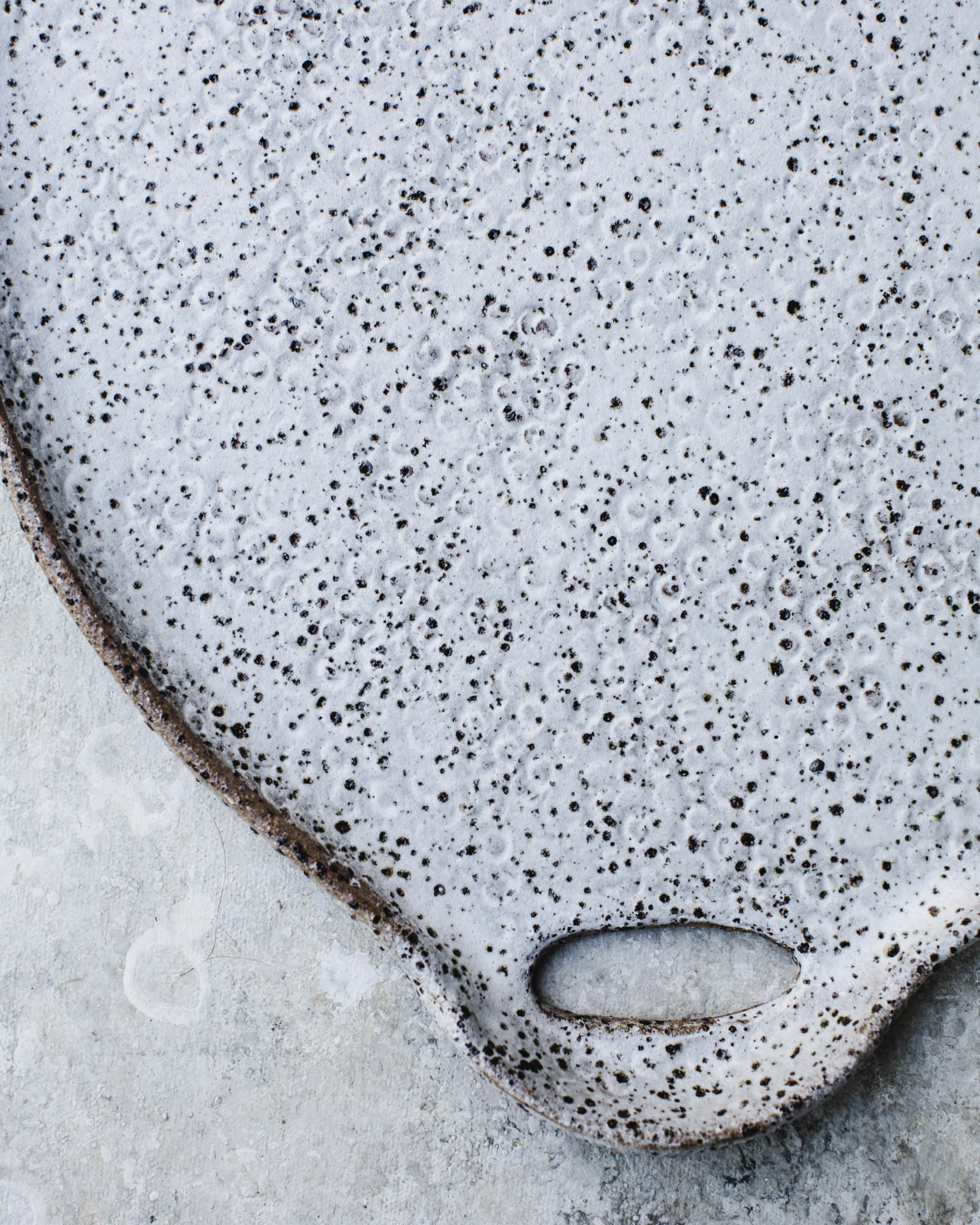 Patterned textured speckled satin white platter with cutout handles by clay beehive ceramics