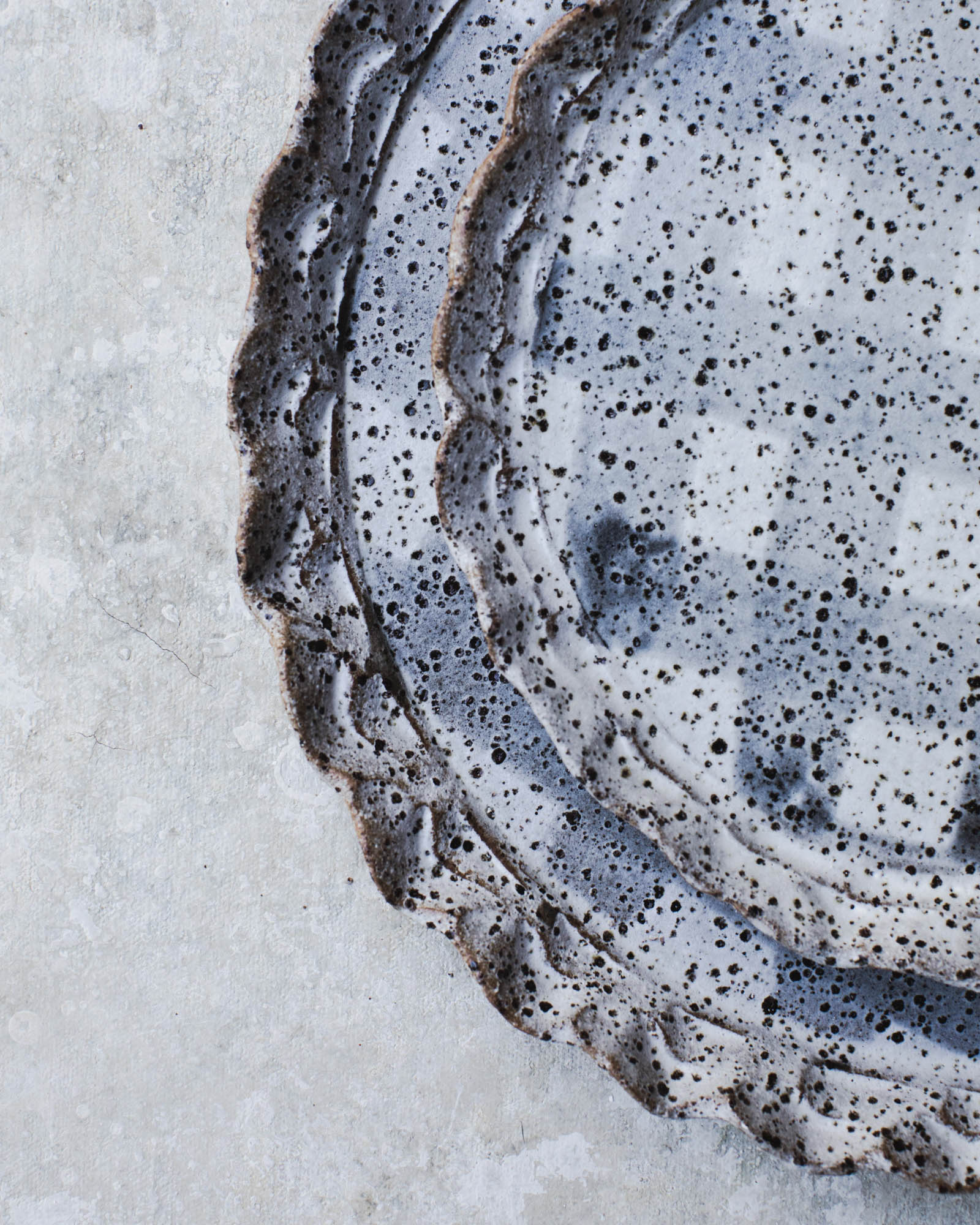 Double rimmed plates in speckled tartan pattern by clay beehive ceramics