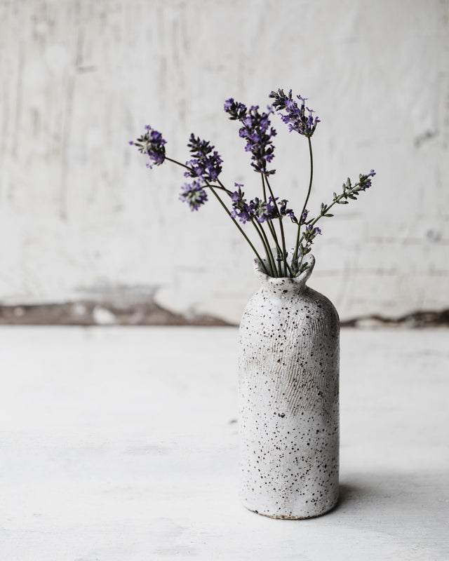 rustic hand made bottle vase with petal rim and satin white speckle surface by clay beehive ceramics