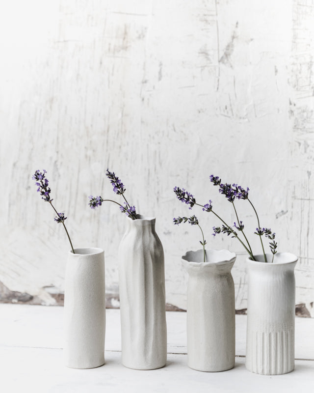 White tall slender vases with exposed raw clay exterior