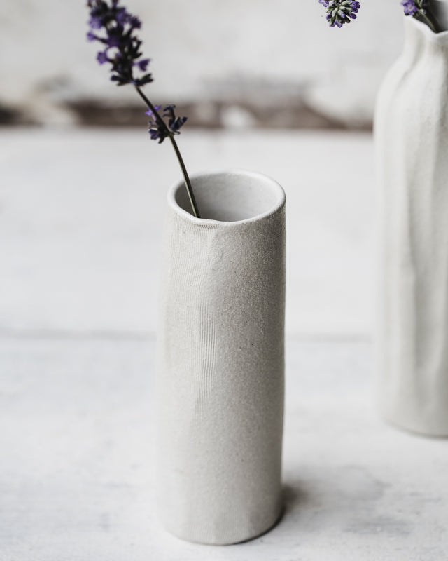 White tall slender vases with exposed raw clay exterior