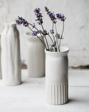 White tall slender vases with exposed raw clay exterior