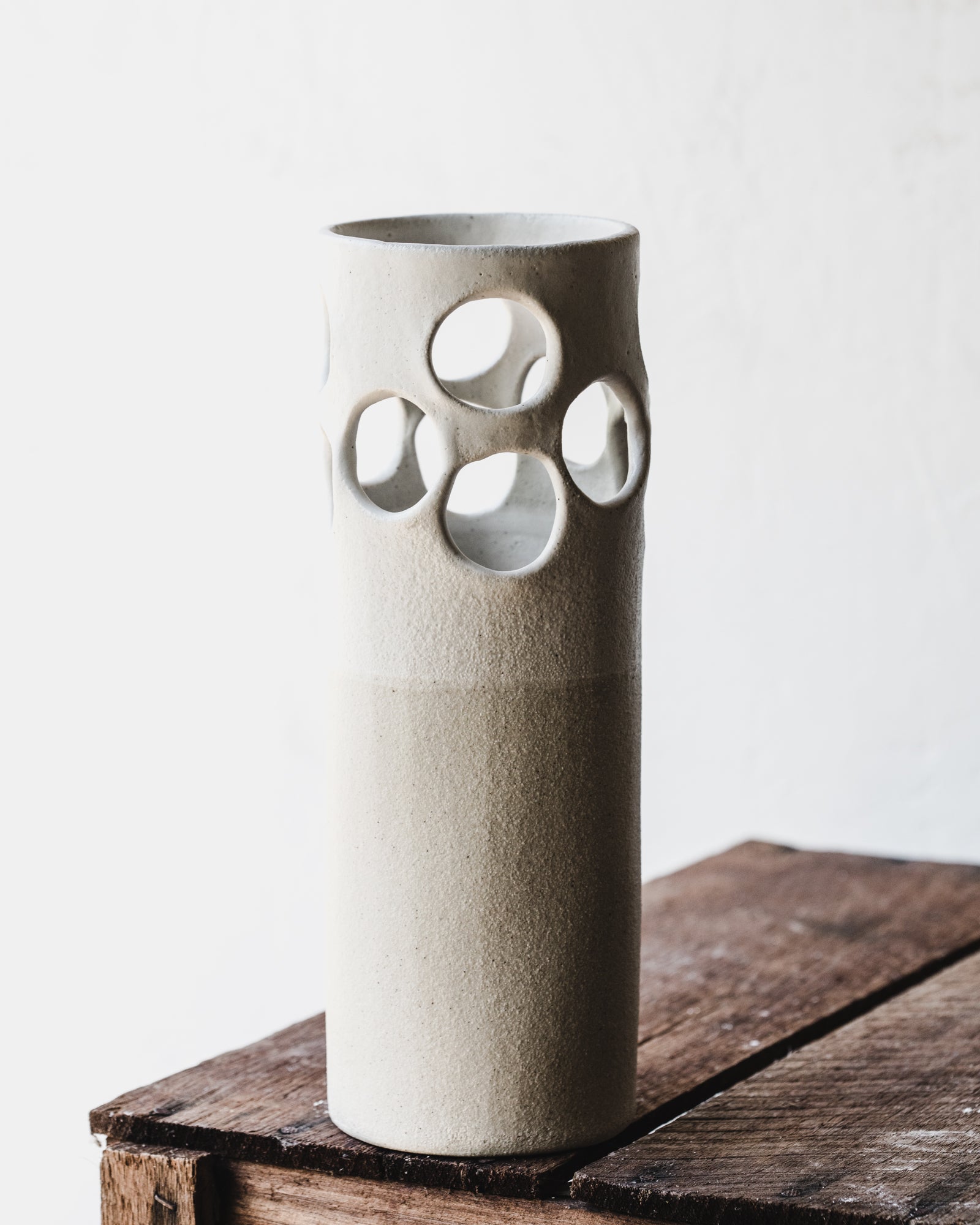 large circles cutout vase in satin white textured finish handmade by clay beehive ceramics