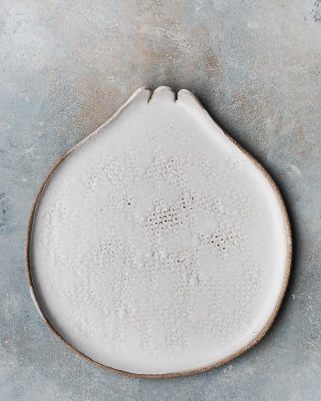 Pomegranate shaped plates in a satin white rustic finish with texture by clay beehive ceramics.