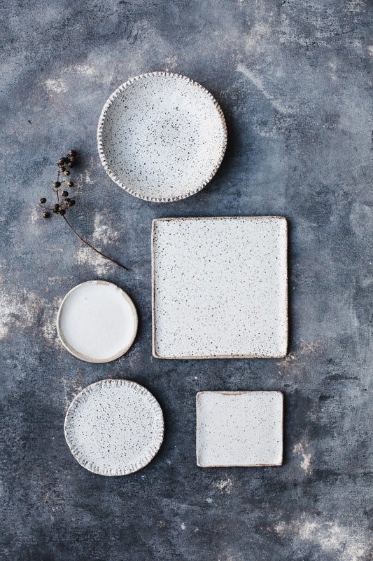 Rustic speckled bowl and plates in satin white by clay beehive ceramics