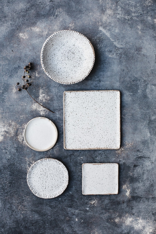 Rustic speckled bowl and plates in satin white by clay beehive ceramics