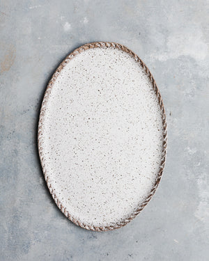 Rustic speckled white oval platter with textured edging by clay beehive ceramics