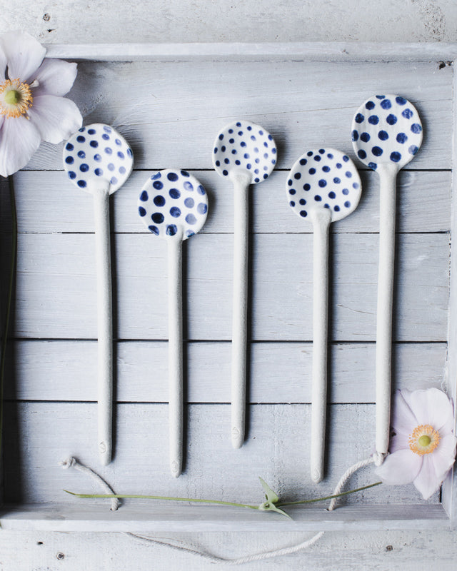Hand made blue and white ceramic spoons with spots by clay beehive