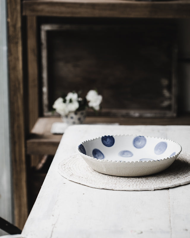 Scallop rim bowl with blue and white polka dot handmade by clay beehive 