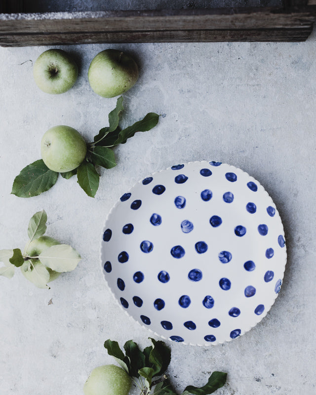 large hand made ceramic bowl with blue spots and satin white glaze by clay beehive