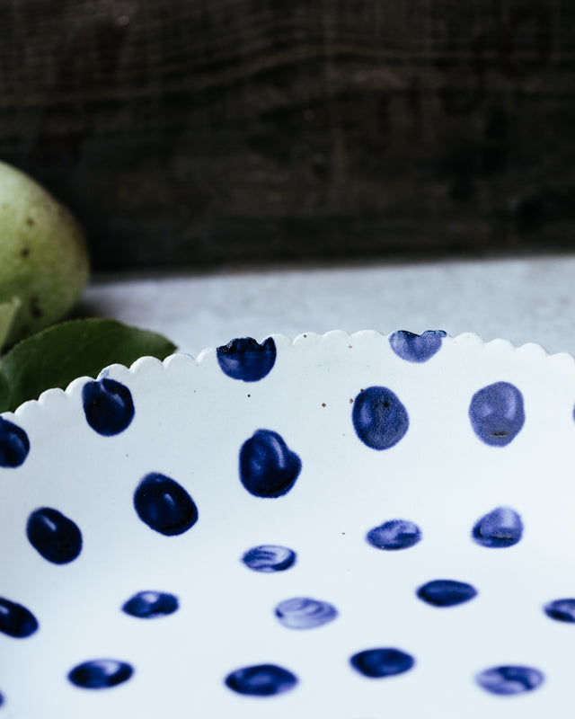 large hand made ceramic bowl with blue spots and satin white glaze by clay beehive