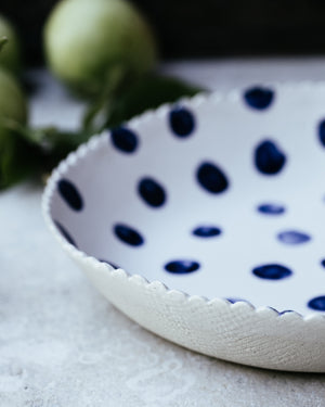 large hand made ceramic bowl with blue spots and satin white glaze by clay beehive