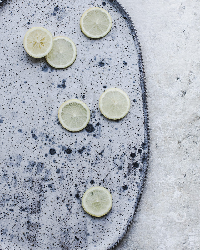 Large hand made ceramic platter with speckled surface design and textured rim by Clay Beehive