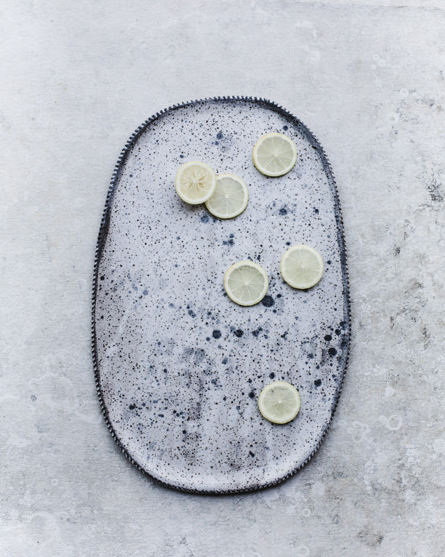 Large hand made ceramic platter with speckled surface design and textured rim by Clay Beehive