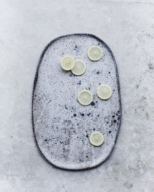 Large hand made ceramic platter with speckled surface design and textured rim by Clay Beehive