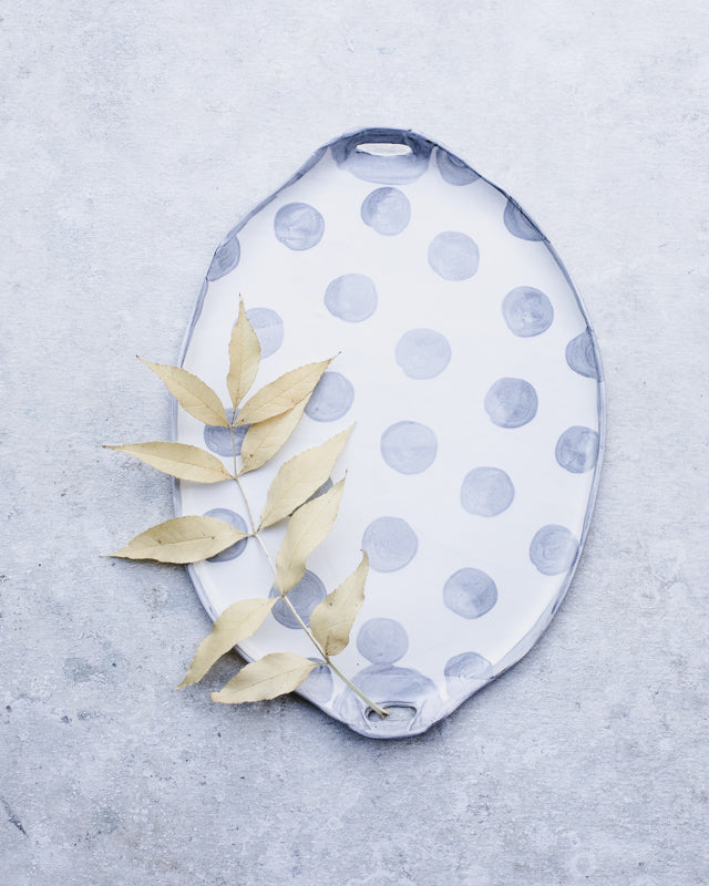 Polka dot hand made platter in grey and white with cutout handles by clay beehive ceramics