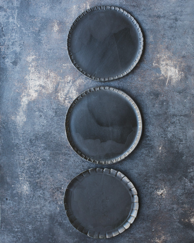 ceramic hand-made plates by clay beehive with carved rims and satin black glazing
