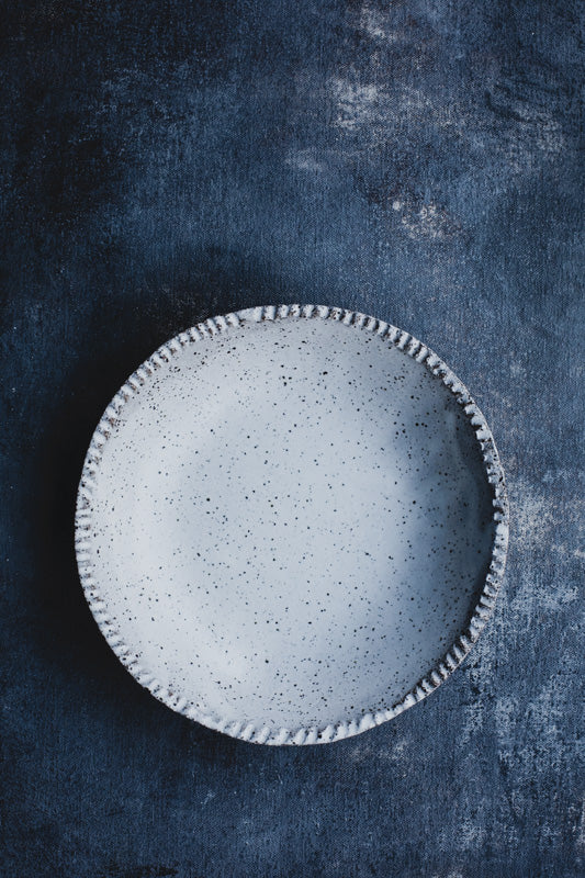 Rustic satin white speckle bowl with textured rim detail