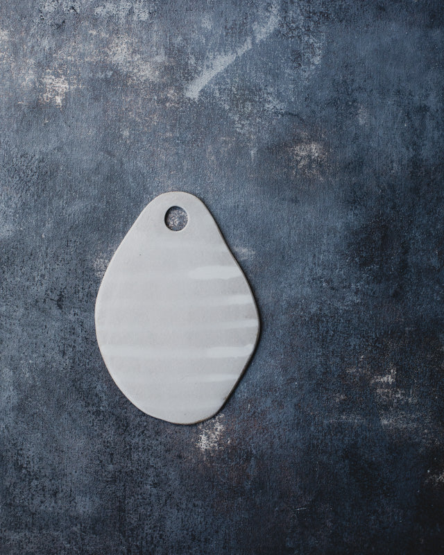 Platters and flat plates glazed in satin white over warm speckle clay body by clay beehive