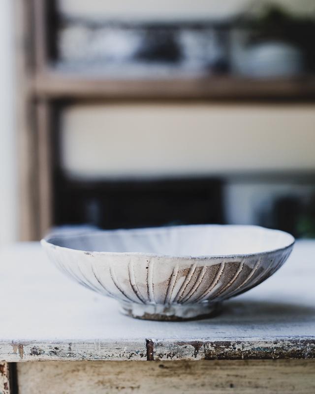 carved berry bowl colander with foot handcrafted in a dark stoneware clay by clay beehive ceramics