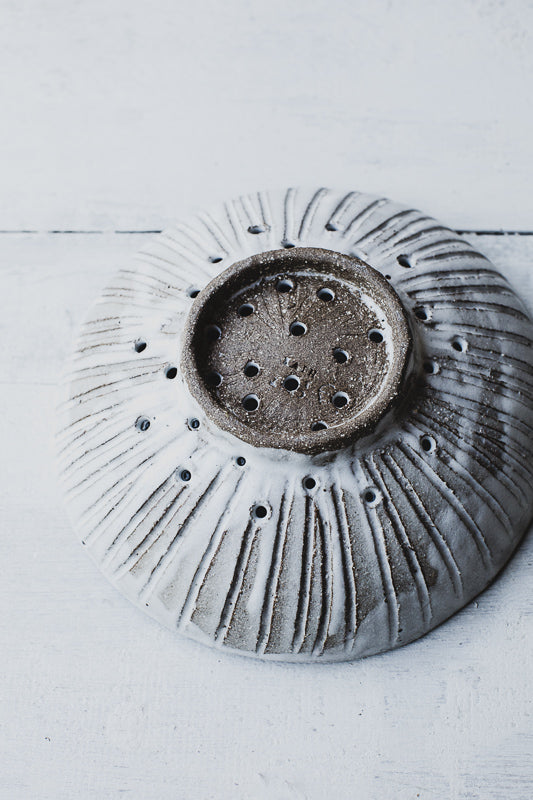 carved berry bowl colander with foot handcrafted in a dark stoneware clay by clay beehive ceramics