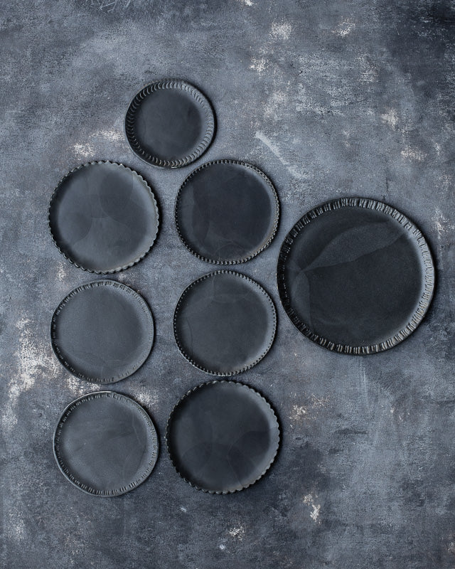 Satin matte black charcoal plates with carved rims hand made by clay beehive ceramics