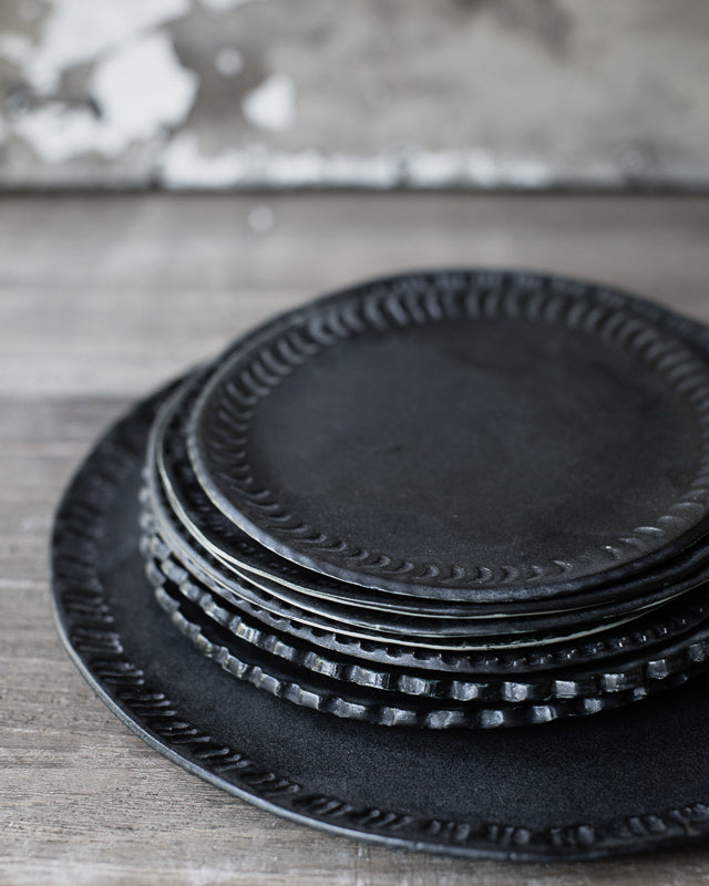 Satin matte black charcoal plates with carved rims hand made by clay beehive ceramics