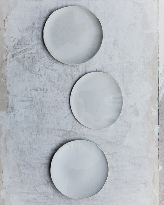satin white plates with organic shaped curve and gritty clay by clay beehive ceramics