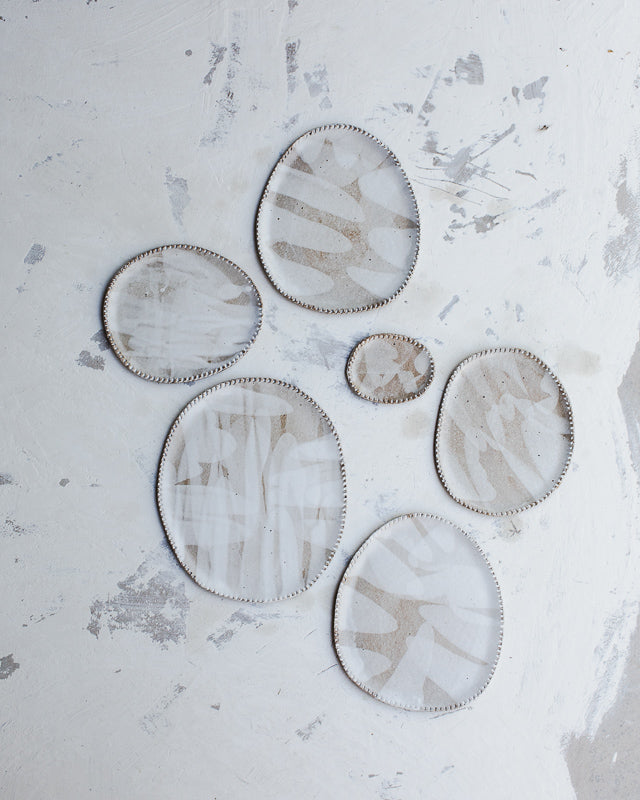 Oval rustic ceramic plates with textured edging and satin white glaze created by clay beehive ceramics