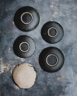 black gritty shallow footed bowls / plates ceramic by clay beehive