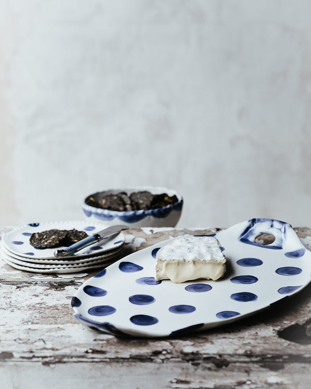 navy blue polka dot oval hand made ceramic platter with handles and perfect as a cheese board by clay beehive 