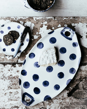 navy blue polka dot oval hand made ceramic platter with handles and perfect as a cheese board by clay beehive 