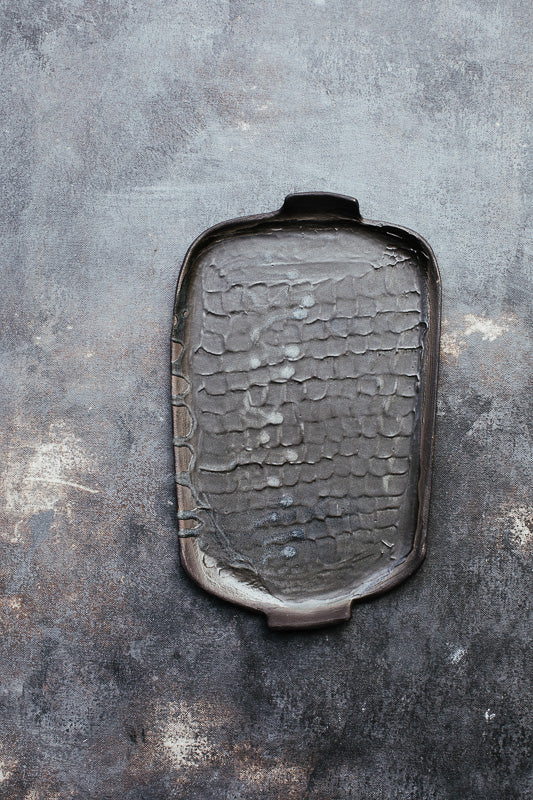 wabi sabi plates with matte black glaze and textured surface hand made by clay beehive ceramics