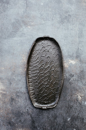 wabi sabi plates with matte black glaze and textured surface hand made by clay beehive ceramics