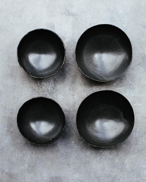 flat lay of wabi sabi footed matte black bowls deeper interior noodles soups hand made by clay beehive ceramics