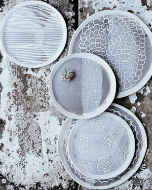 ceramic hand made plate with carved texture and pattern in grey and white matte by clay beehive