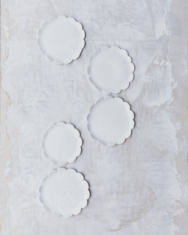 satin white hand made ceramic plates with petal curved rims by clay beehive