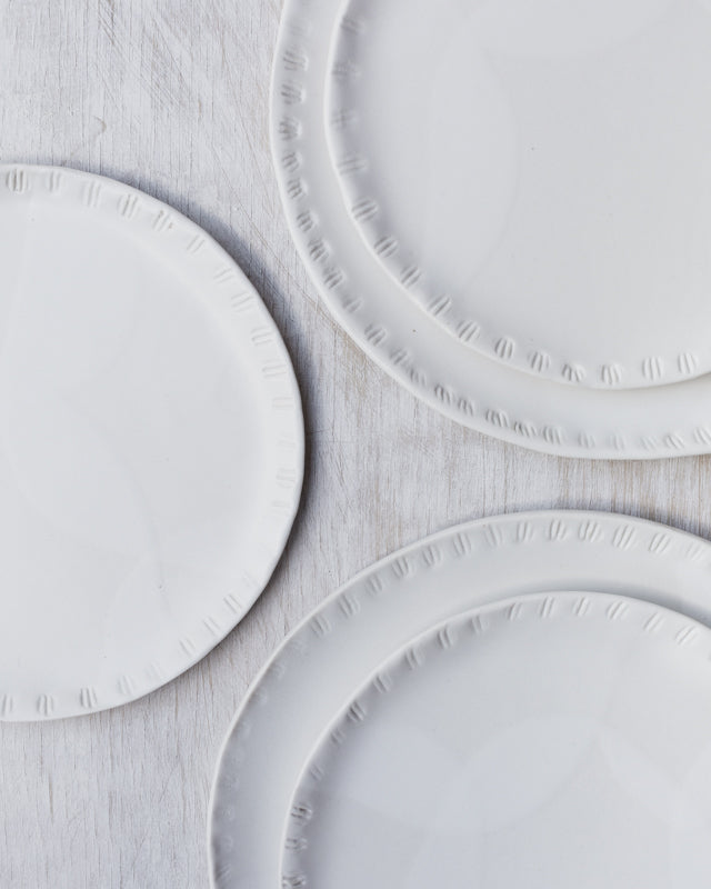 Satin white carved seashell rim plates