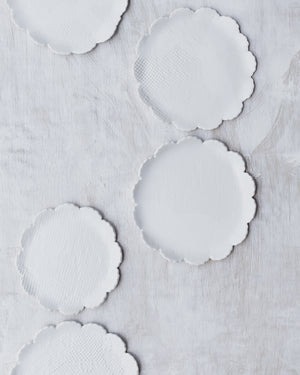 satin white hand made ceramic plates with petal curved rims by clay beehive