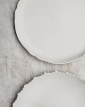 Satin white hand made plates with decorative rims by clay beehive ceramic