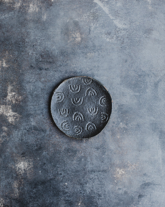 hand made ceramic black gritty plate with carved rainbow pattern by clay beehive