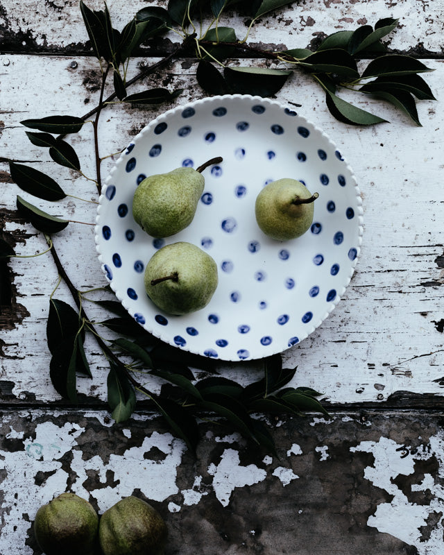 large hand made ceramic bowl with blue spots and satin white glaze by clay beehive