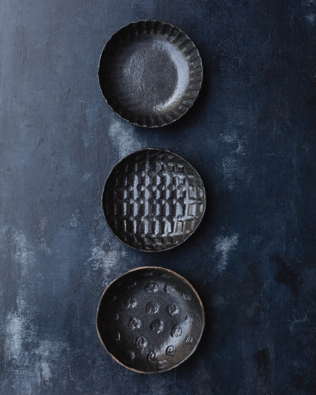 hand made ceramic bowls with heavy hand carved texture glazed in satin black by clay beehive