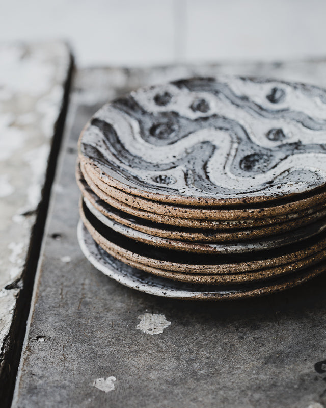 hand made ceramic rustic tapas sharing plates with carved designs glazed in satin black and white by clay beehive 