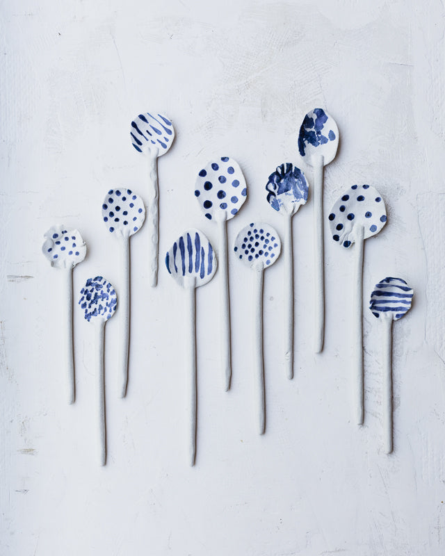 hand made ceramic spoons decorated in blue and white spots and stripes by clay beehive