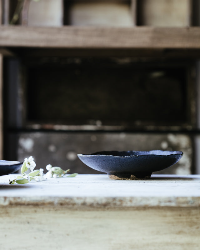 black stoneware footed bowl handmade by clay beehive ceramics